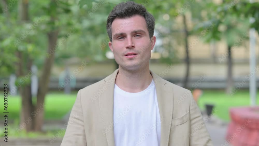 Outdoor Portrait of Casual Young Man in Denial, Stop Gesture Outdoor Portrait of Casual Young Man in Denial, Stop Gesture