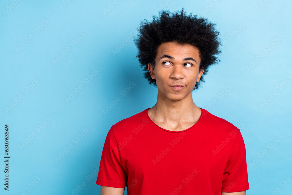 Portrait of minded nice person look interested empty space contemplate brainstorm isolated on blue color background Portrait of minded nice person look interested empty space contemplate brainstorm isolated on blue color background