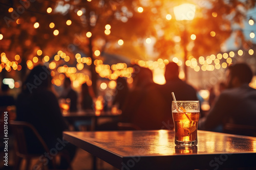 Crowd of people sitting in a pub and drinking beer. Blurred background