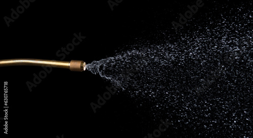 Spray jet water pressure nozzle isolated on black background photo