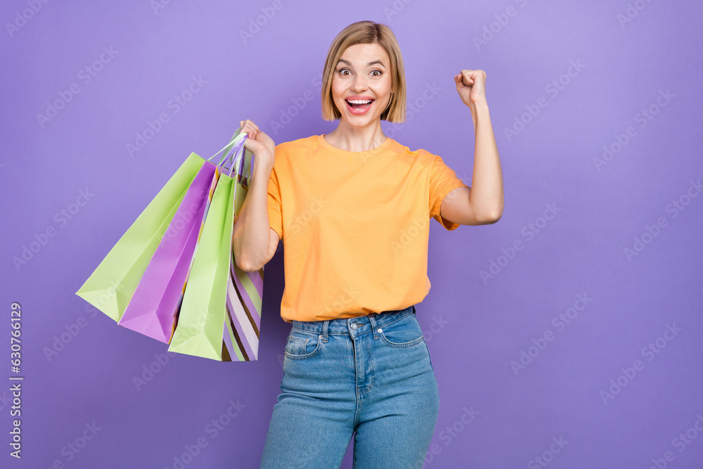 Photo of young girl enjoy every black friday sales outlet brands fist up celebrate wear stylish apparel isolated on violet color background Photo of young girl enjoy every black friday sales outlet brands fist up celebrate wear stylish apparel isolated on violet color background