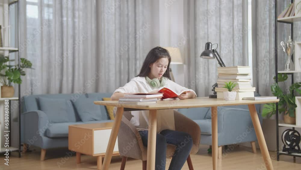 Tired Asian Teenager Yawning And Sleep On The Table At Home After Doing Home Work
