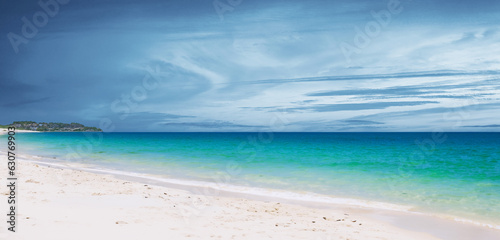 Fototapeta Naklejka Na Ścianę i Meble -  Seaside on a cloudy day White sandy beach Clear blue water 3d illustration