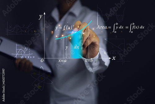 Teacher or students hands are graphing showing the integration in the calculus section of mathematics. is a function to find the area under the curved graph must use the integral. photo