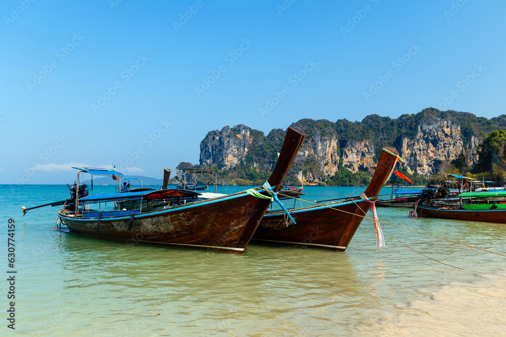 Longtail tourist boats anchored on the beach in Thailand