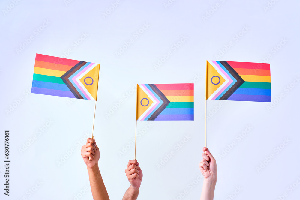 hands with lgbtqi sexual diversity flags on white background hands with lgbtqi sexual diversity flags on white background