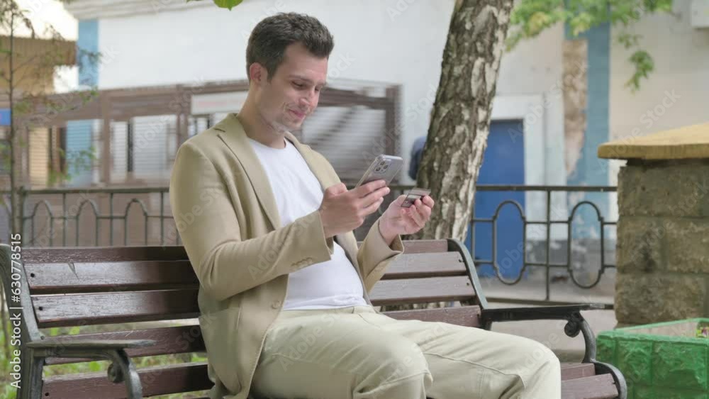 Young Man Doing Online Shopping on phone while Sitting Outdoor Young Man Doing Online Shopping on phone while Sitting Outdoor