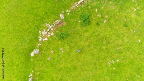 Aerial view of female tourist exploring the famous Beltany stone circle, Ireland photo