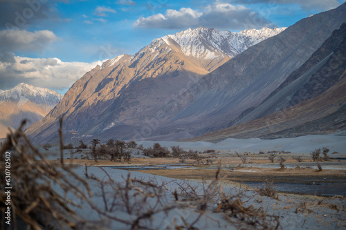 Low-angle landscape image of Himalayan mountain in Hunder, Nubra Valley, Ladakh, India. Wallpaper concept, landscape image of Desert and mountains during sunset.