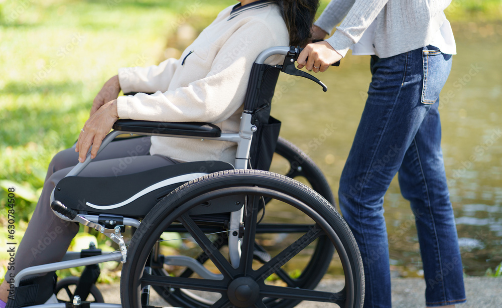 Nursing home. Young caregiver helping senior woman in wheelchair. Nursing home. Young caregiver helping senior woman in wheelchair.