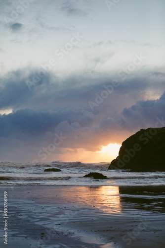 Moody sunset photo of the ocean from the Pacific Coast Highway with rich blue and purple colors.