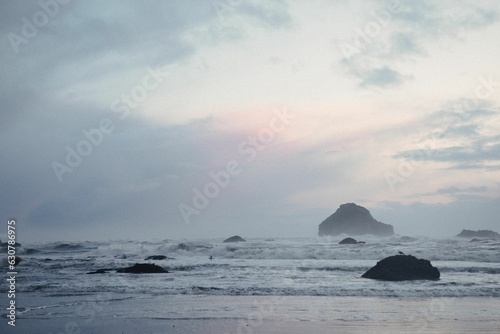 Moody sunset photo of the ocean from the Pacific Coast Highway with rich blue and purple colors.