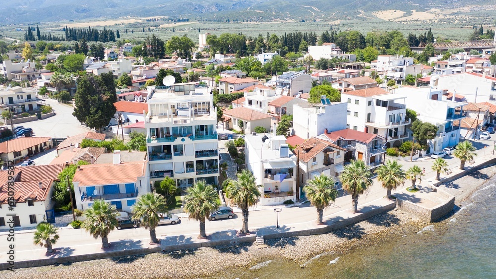 Aerial view of houses on the coastline against the sea on a sunny day Aerial view of houses on the coastline against the sea on a sunny day