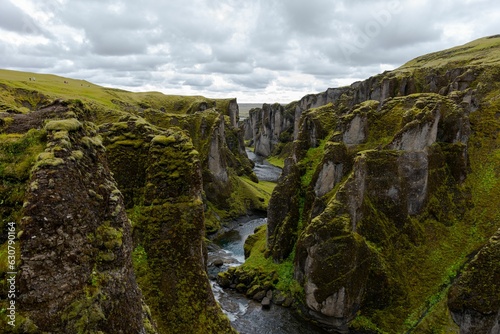 Fjadrargljufur valley near some mountains with moss growing on them in Iceland
