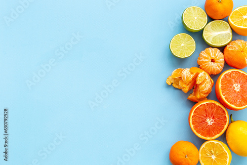 Mixed fruits background layout - many citrus slices top view.