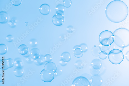 Beautiful Transparent Blue Soap Bubbles Floating in The Air. White Space  Abstract Fun Background  Blue Gradient Blurred Background  Refreshing of Soap Suds Bubbles Water.