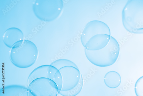 Beautiful Transparent Blue Soap Bubbles Floating in The Air. White Space  Abstract Fun Background  Blue Gradient Blurred Background  Refreshing of Soap Suds Bubbles Water.