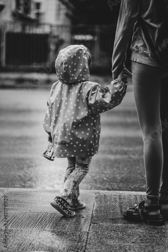 mother with her child on the street in varna bulgaria on a rainy day