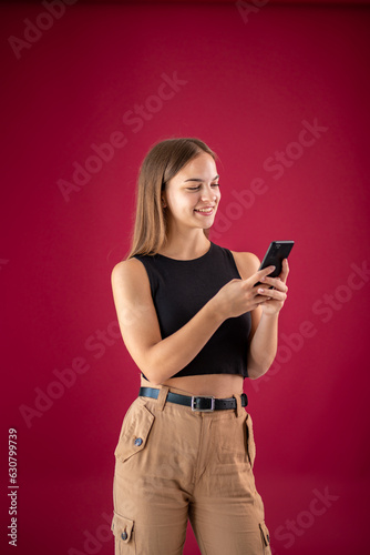 a young woman in a black T-shirt uses a mobile phone