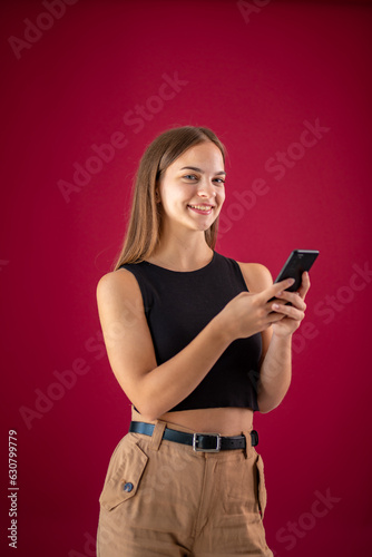 a young woman in a black T-shirt uses a mobile phone