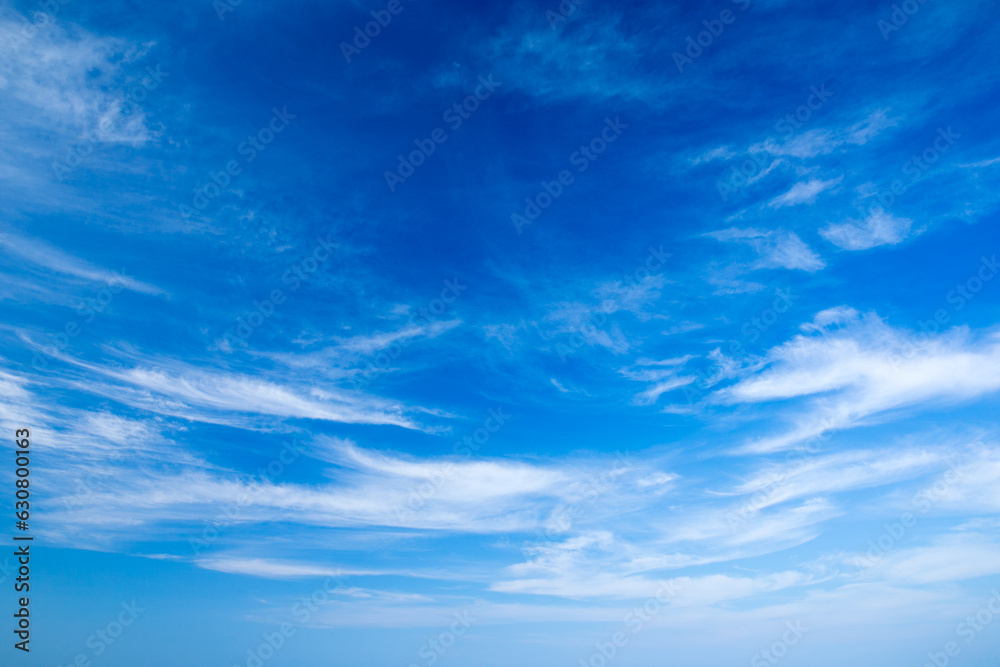 blue sky background with tiny clouds