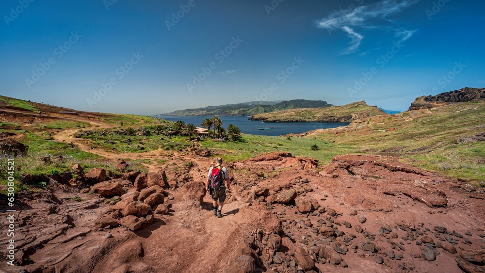 Person taking an exciting journey on a dirt road, exploring down a steep and rocky hillside path