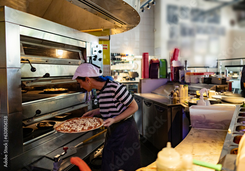 young pizzeria woman working in italian restaurant
