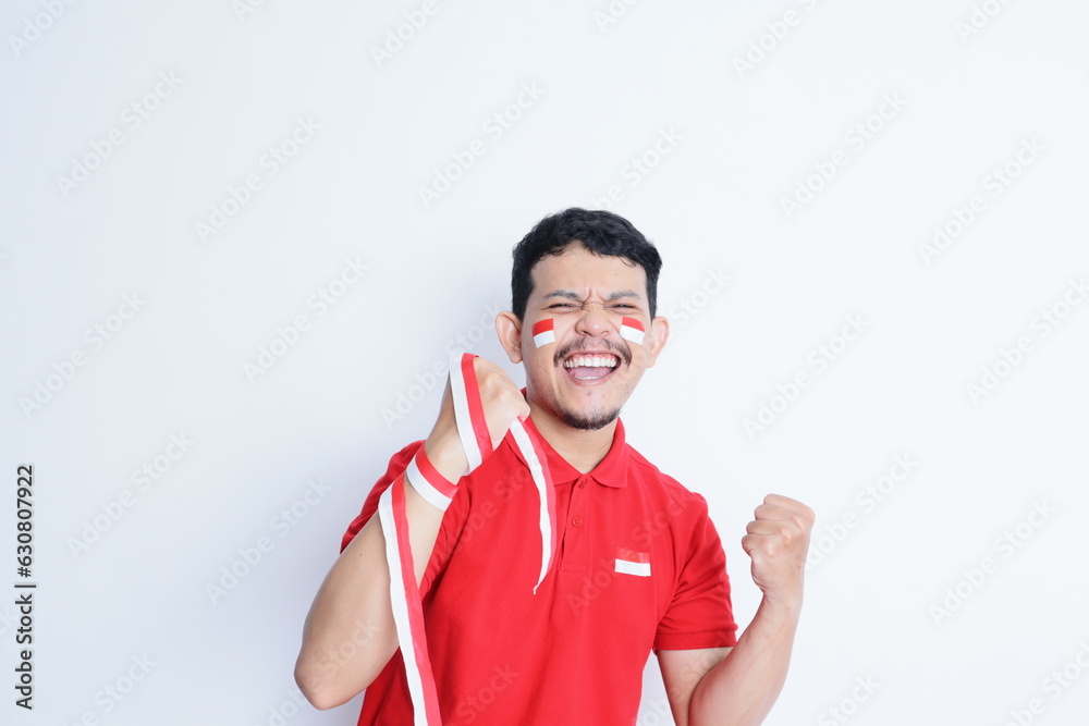 Indonesian man clenched both fist showing excitement when celebrating independence day Indonesian man clenched both fist showing excitement when celebrating independence day