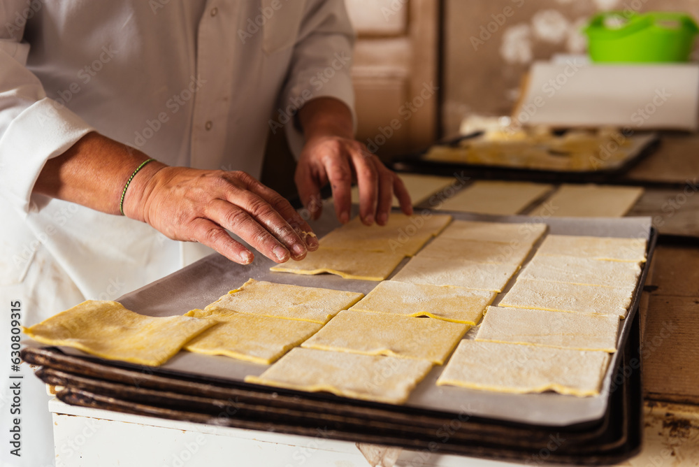 Unrecognizable chef standing at table and preparing pasta dough Unrecognizable chef standing at table and preparing pasta dough
