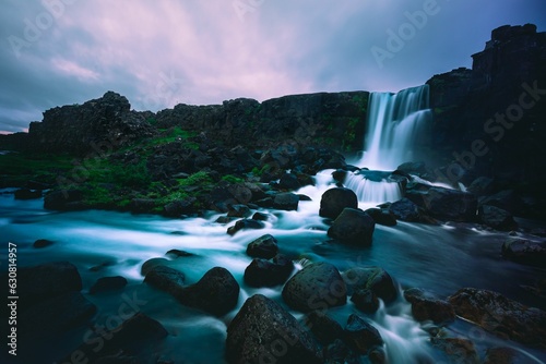 the river flowing down a cliff with water casing over rocks