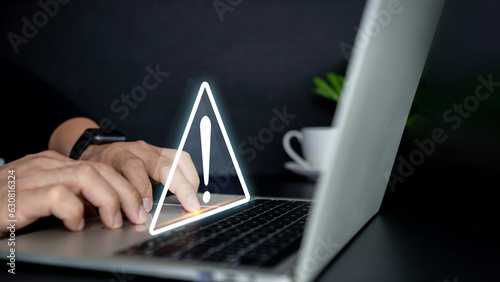 Businessman using computer laptop with triangle caution warning sing , Http 404 error not found page template concept.