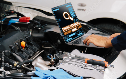 Smart Car Service Diagnostics Software concept.Mechanic using digital tablet Inspecting the Vehicle