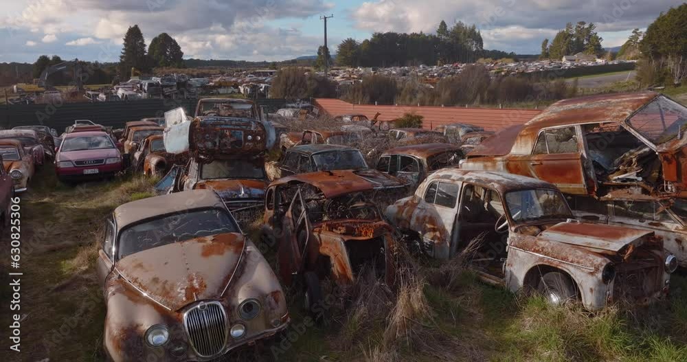 Aerial: Abandoned junk rusted cars in junkyard, New Zealand