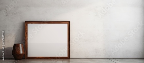 A vintage wooden frame is placed on a white cement wall and black marble floor with a shadow in the background. empty space available for mock-ups and templates.