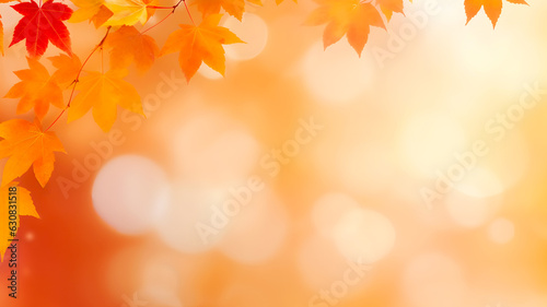 Defocused autumn background with bokeh and blurry red yellow and orange autumn leaves