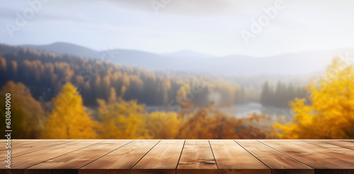 Empty wooden table with autumn landscape banner. Selective focus on tabletop. 