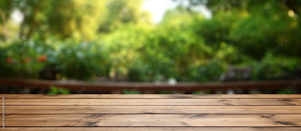The wooden table is empty with a blurry outdoor garden background. It is a blank space for marketing promotion, with space for text. The wooden table is empty with a blurry outdoor garden background. It is a blank space for marketing promotion, with space for text.
