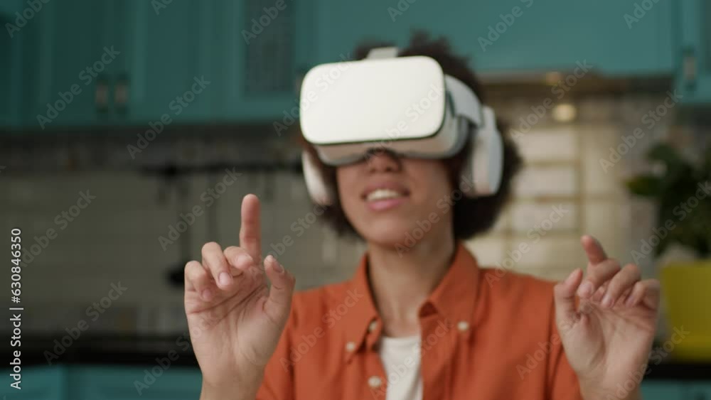 Woman in Virtual Reality Headset Gesturing with Hands. 20s female wearing VR googles. Typing in virtual reality.