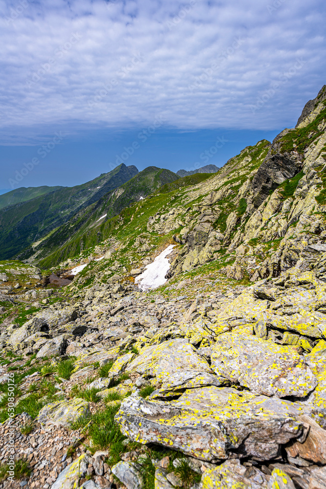 Summer landscape of the Fagaras Mountains. View from the hiking trail from Lake Balea to Mount Negoiu. Amazing rock formations of the Carpathians, Romania.