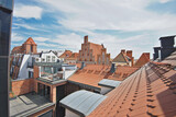 Roofs and brick buildings in the old town of Torun in Poland. The view from the terrace in sunny summer day.