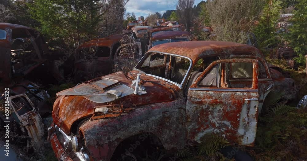 Aerial: Abandoned junk rusted cars in junkyard, New Zealand