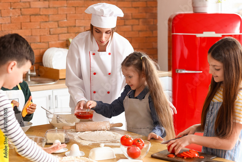 Female chef with group of l...