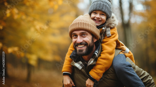 father and son playing and enjoying in nature on autumnal forest