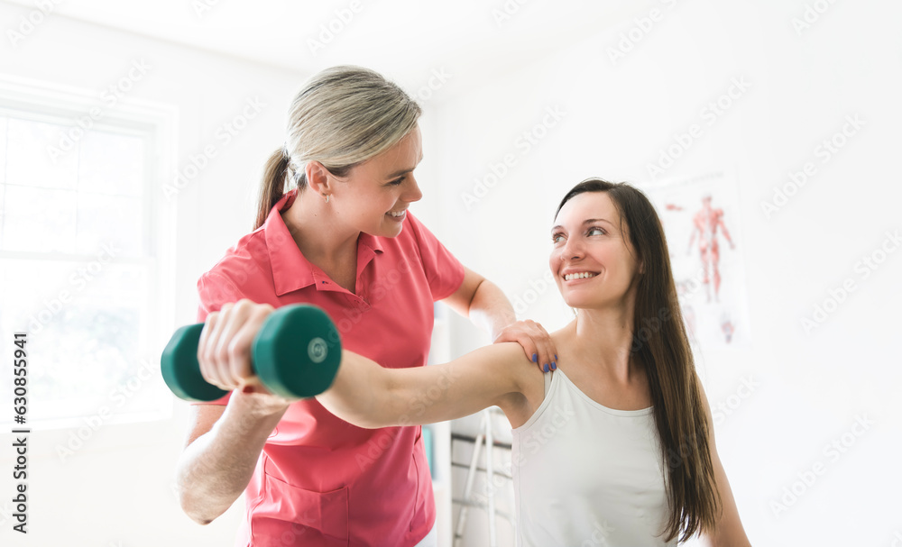 Modern rehabilitation physiotherapy clinic with professional and client Modern rehabilitation physiotherapy clinic with professional and client