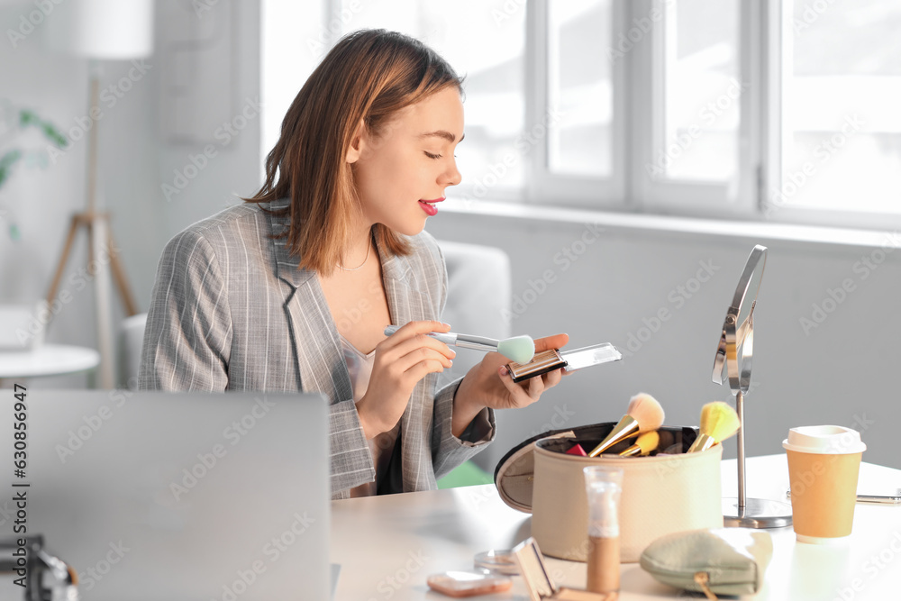 Female beauty blogger with makeup powder recording video at home Female beauty blogger with makeup powder recording video at home
