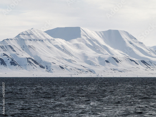 Landscape of Arctic Ocean with shore, hills, snow and sea, Spitsbergen  © Natalia