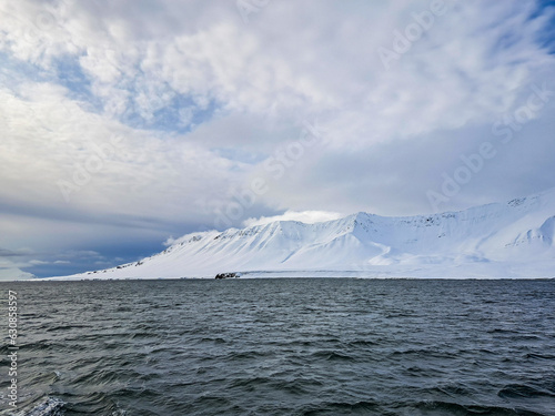Landscape of Arctic Ocean with shore, hills, snow and sea, Spitsbergen 