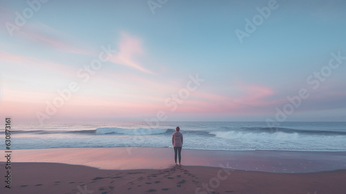 A woman standing at a cliff in solitude and grief longing for past memories in a process of self-reflection and discovery