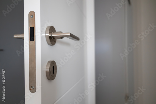 Close up view of magnetic  lock and handle  on white door. Interior design. Beautiful backgrounds.