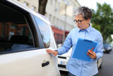 A businesswoman gets a parking ticket, a salesman who works for a car dealer.